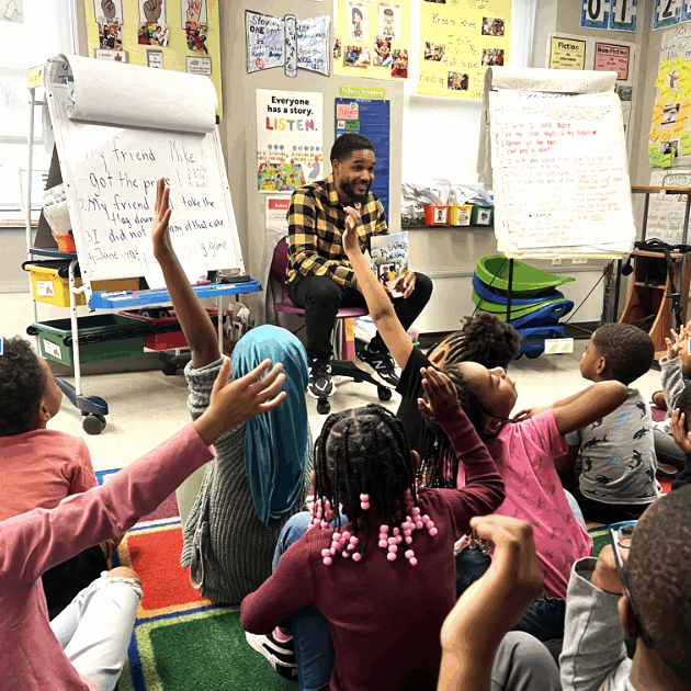 students classroom students raising their hand in a classroom